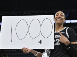 A'Ja Wilson posa con un cartel de '1000' por su récord.